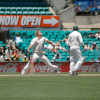 A player bowling the ball at a cricket game