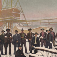 A postcard with a photo of a group of men, some of whom are holding snowballs, gathered in front of a Ballarat gold mine
