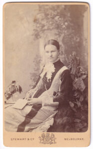 Carte de visite, with a photograph of a woman, from the late 19th century